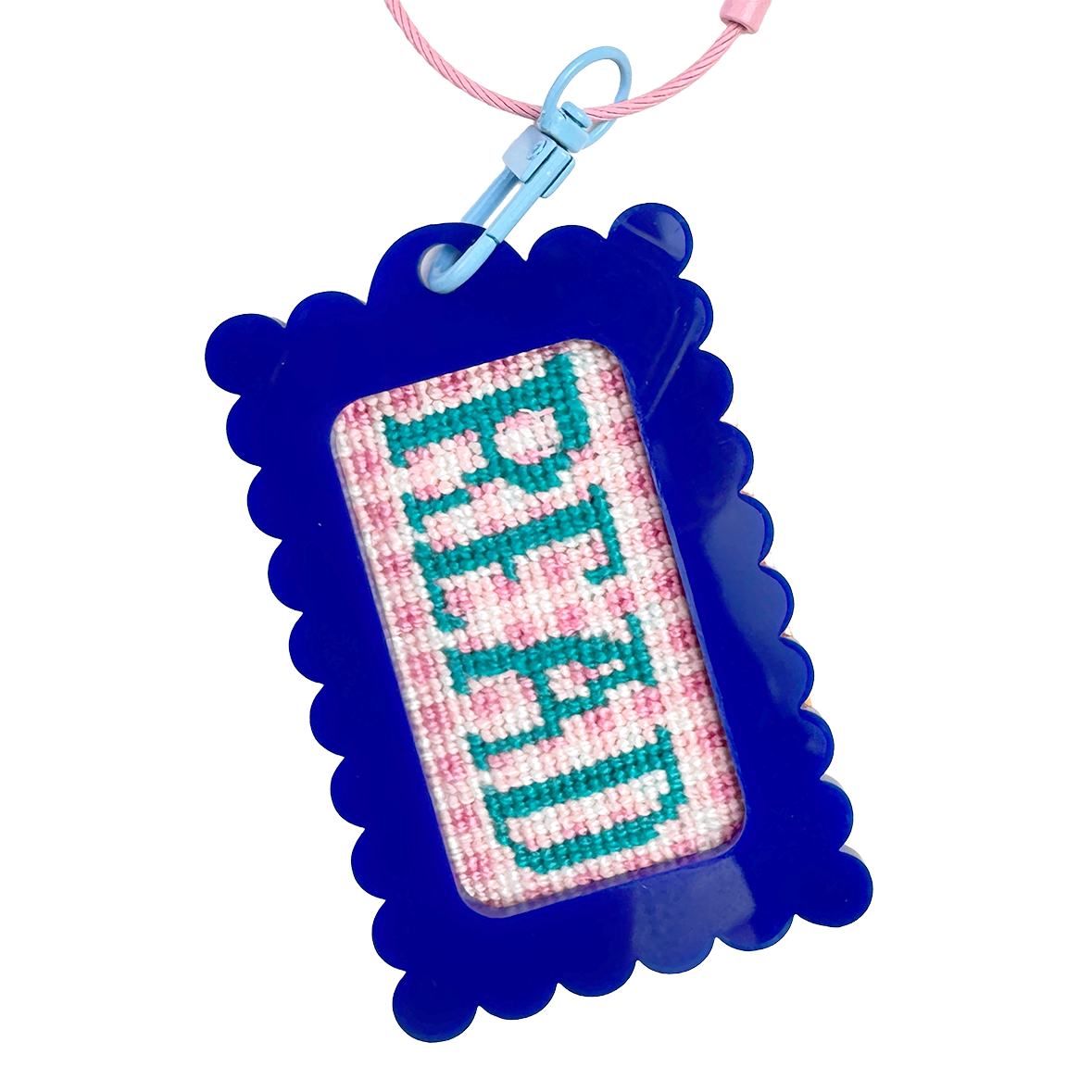 Cross-stitched keychain with 'Read' text in a blue bag tag frame against a white background