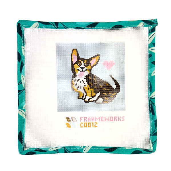 Needlepoint canvas kit with a corgi dog design and 'Fraymeworks' branding on a white background.