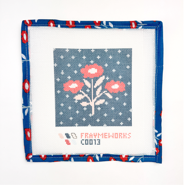 Needlepoint canvas red white and blue floral design on fabric with floral border and Handker design .