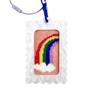 Needlepoint rainbow design in a bag tag keychain white frame with a blue clip against a white background